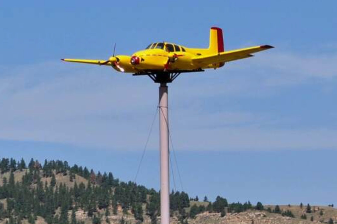 The Quaal Windsock is a 1950s Beechcraft Twin Bonanza on top of a 70-foot pole outside Sundance, Wyoming, along Interstate 90.