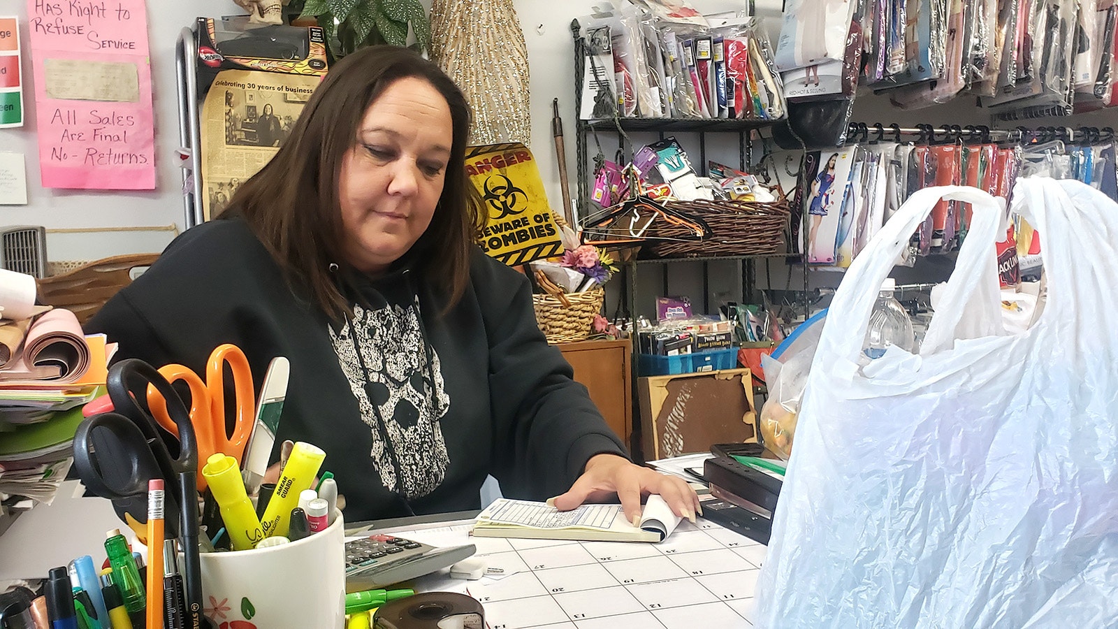 Desiree Ross fills out a sales slip at her thrift store Second Treasures in Worland. Every year for Halloween she fills the store with costumes. Hers is the only Halloween shop for miles around.