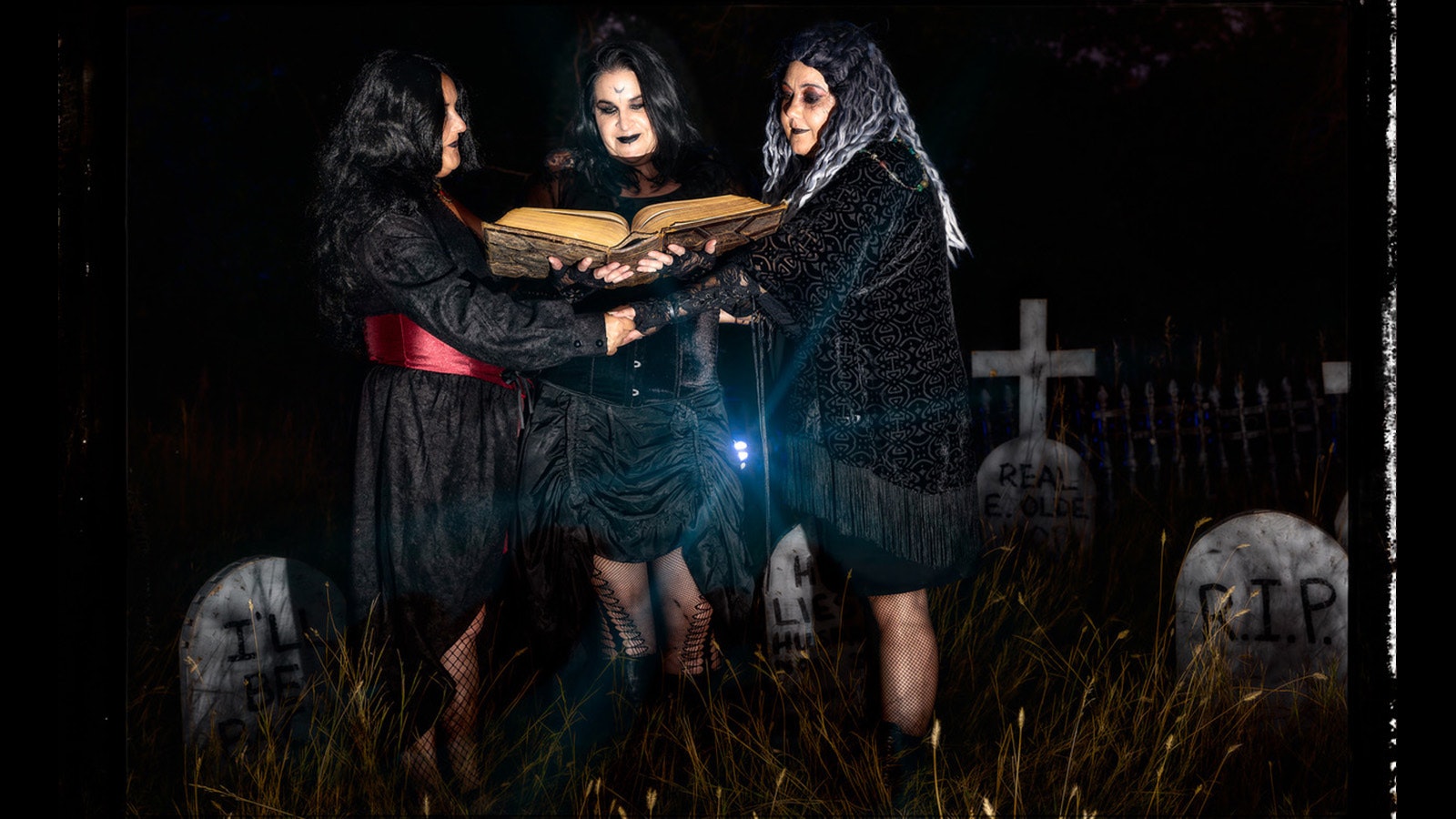 Desiree Ross, Melissa Goode and Sheena Tilley conjure up some spirits in their spooky graveyard.