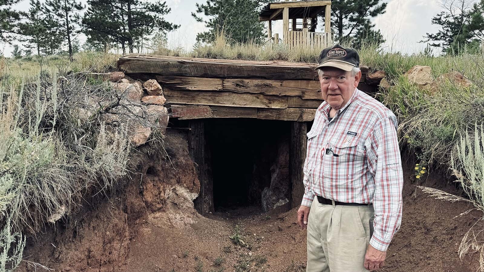 Above, John Davis stands in front of an underground mine that he had a contractor dig out of a hillside behind his home. His grandchildren play in the mine and try to find “jewels” that Davis hid there.