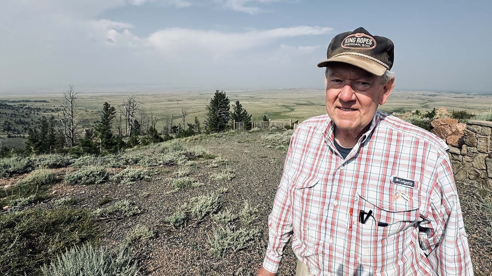 John Davis, a homeowner in the Fish Creek Ranch Preserve, walks past Ponderosa pines that line hills to the east of Laramie Plains where a Spanish energy company wants to build a 500-megawatt wind farm.