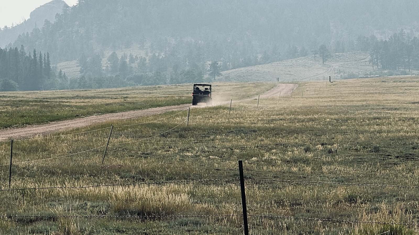 Above, John Davis of the Fish Creek Ranch Preserve, rides along Elk Crossing Road with his Polaris Ranger in order to get around in southeastern Albany County. A Spanish energy company wants to build over 100 wind turbines in the Laramie Plains located in the valley below his cabin.