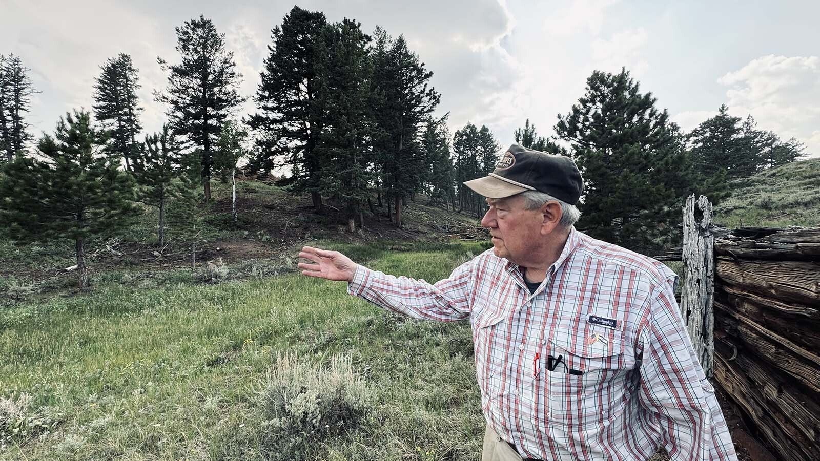 John Davis, a homeowner in the Fish Creek Ranch Preserve, points to the surrounding Ponderosa pines that line the hills to the east of the Laramie Plains where a Spanish energy company wants to build a 500-megawatt wind farm.