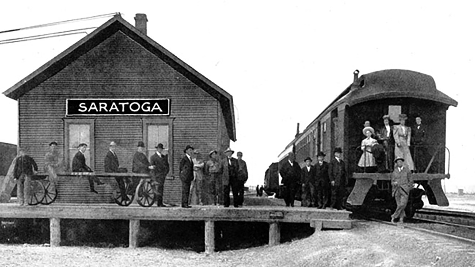 Traveling by train was an event in the early days of Wyoming. In this photo at the Saratoga station, travelers are dressed in their Sunday best to get on the train.