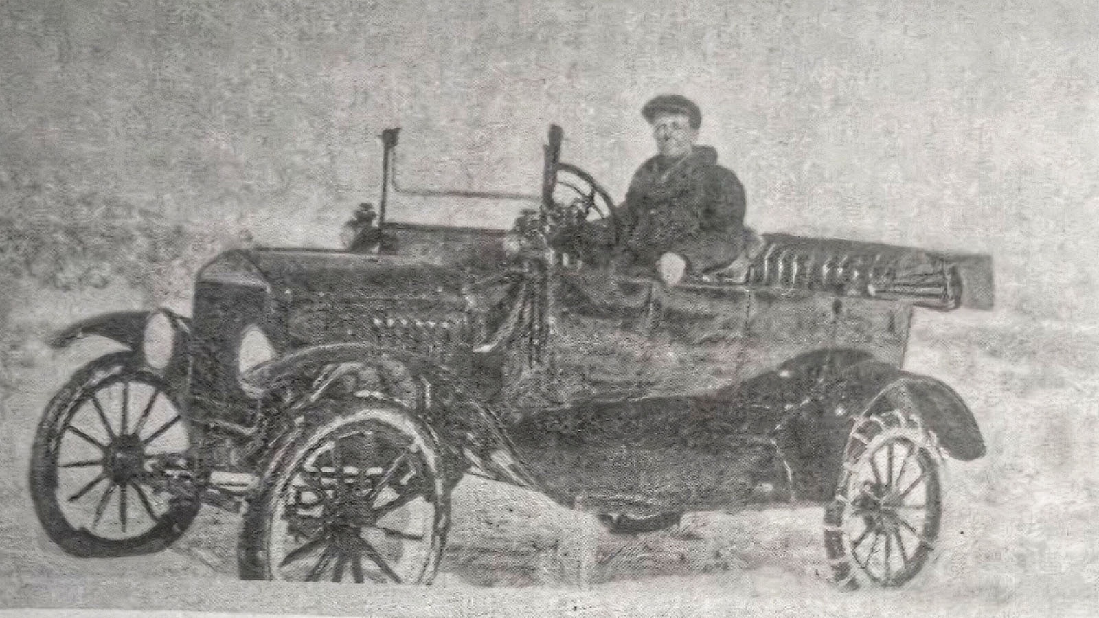 An undated photo of Ralph Faler in his car with chains on his tires. A courier and mail carrier in early Wyoming, he died after being caught in a blizzard in 1921 delivering mail between Pinedale and South Pass City.