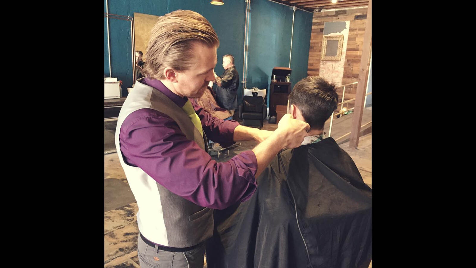 Trevers Chapman gives a haircut at his Gillette barbershop, Rapscallions.