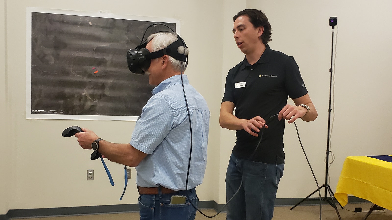Rick Miller, left, takes a virtual reality tour of a future demonstration scale plant for rare earth element processing that's being built in Upton. He is assisted by Paul Bonifas.
