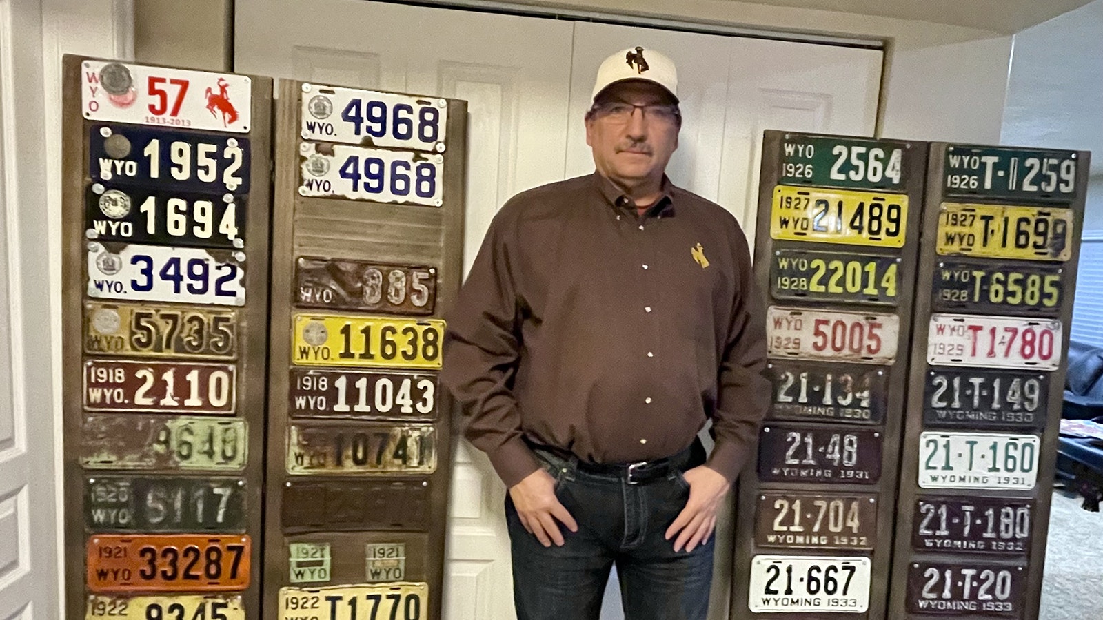 Collin Townsend with a portion of his Weston County license plate run. He has a car and truck license plate from nearly every year between 1914 and 2024.