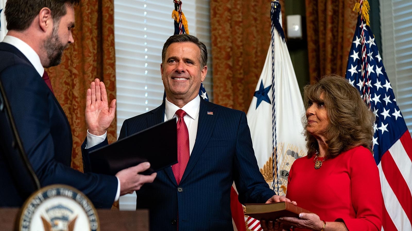 U.S. Vice President J.D. Vance swears in newly confirmed CIA Director John Ratcliffe while his wife, Michele Ratcliffe looks on during a ceremony in the Eisenhower Executive Office Building at the White House on Jan. 23, 2025, in Washington, D.C.