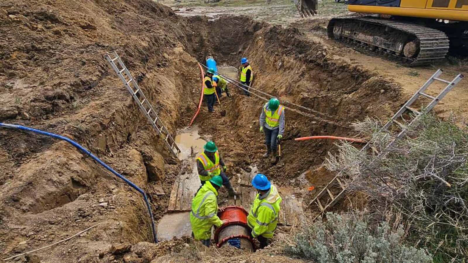 A crew works to repair and replace a failed water line in Rawlins this week.