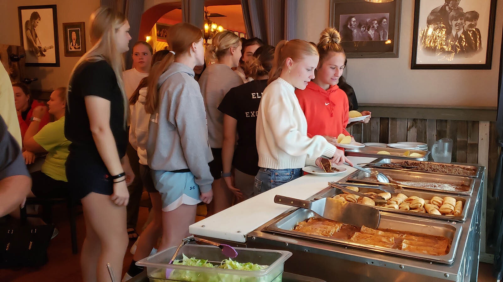 Rawlins High School volleyball team members line up for a free buffet with a choice of tacos, enchiladas and burritos at Mike's Big City Steakhouse in Rawlins. The eatery routinely feeds local sports teams free before they play.