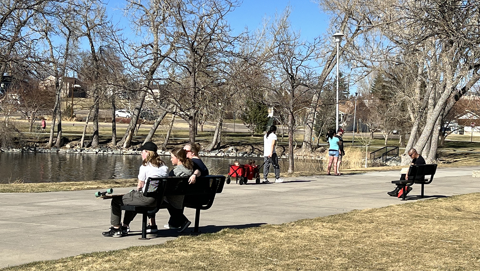 Between Friday and Sunday, Wyoming will transition from sunny skies and near-record high temperatures to rain, clouds, 30- to 35-degree temperature drops, and as much as 18 inches of snow in the mountains. Here, people enjoy a warm fall day at Holiday Park in Cheyenne.