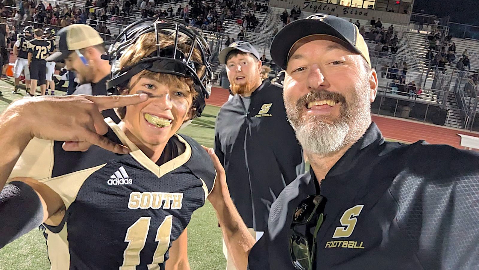 Cheyenne South Senior Keelan Anderson, left, and coach Eli Moody celebrate after Anderson nailed a state-record 61-yard field goal.