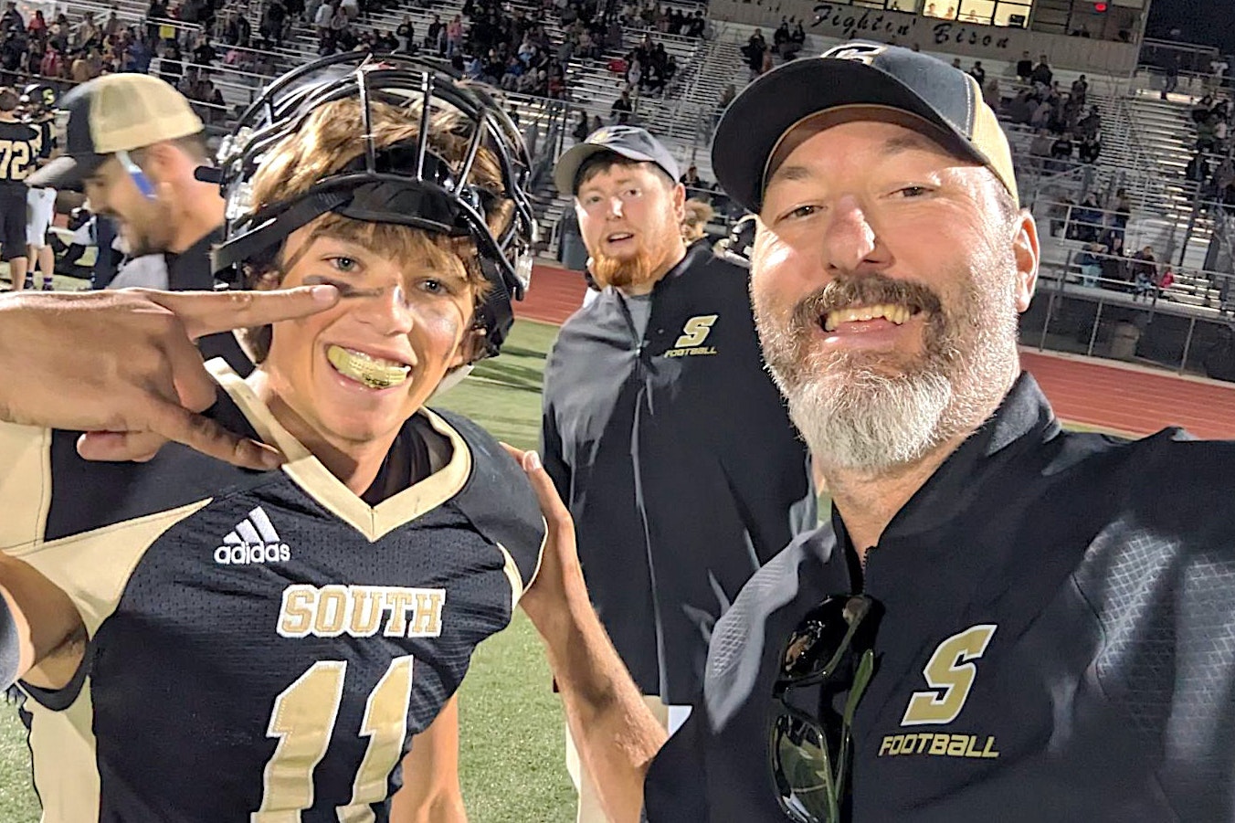 Cheyenne South Senior Keelan Anderson, left, and coach Eli Moody celebrate after Anderson nailed a state-record 61-yard field goal.