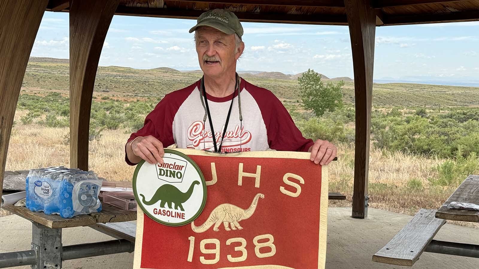 Erik Kvale compares the iconic Sinclair dinosaur to the dinosaur on a Greybull Junior High School banner from 1938. Greybull is internationally renowned for the quantity and quality of its dinosaur fossils, so the local middle school briefly adopted a dinosaur as its logos.