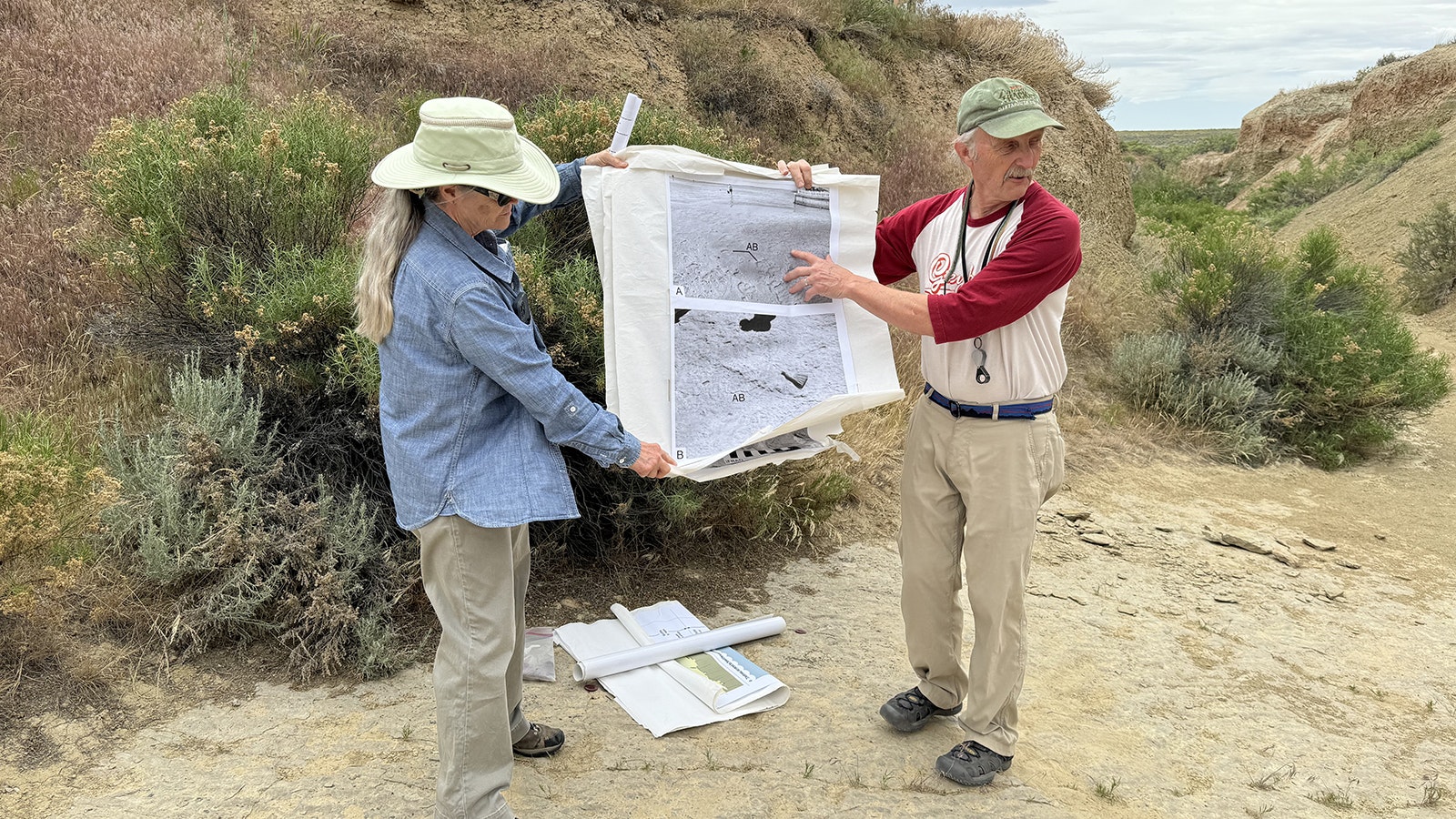 Erik Kvale uses a poster to explain the paleoecology of the Red Gulch Dinosaur Tracksite. Kvale was one of the Greybull residents who discovered the limestone exposure in 1997, which preserves over 800 dinosaur footprints from the Middle Jurassic Sundance Formation.