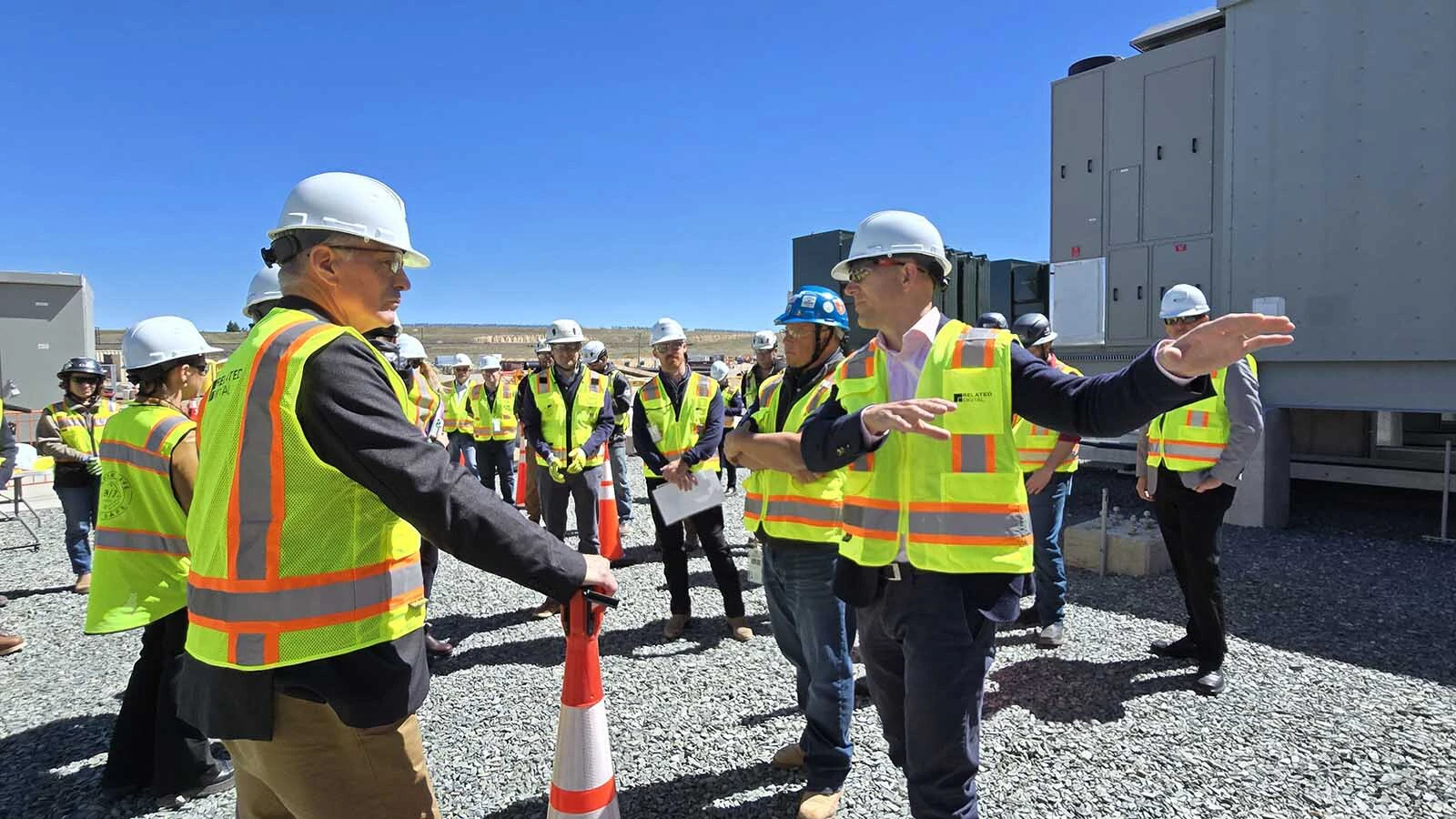 Gov. Mark Gordon, left, listens as Related Digital employees explain how power travels to its data center east of Cheyenne.
