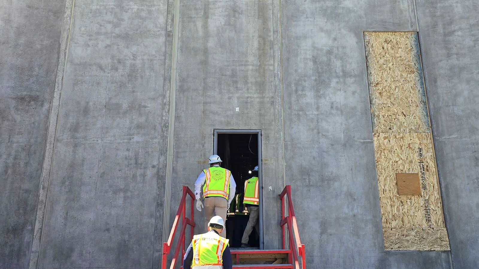 The huge, pre-cast concrete walls dwarf the humans going inside the facility, which is nearing completion of its first phase.
