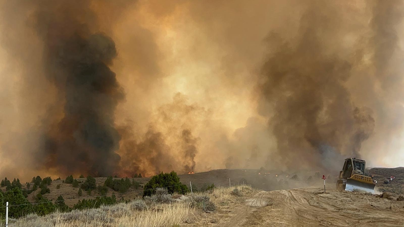 A bulldozer helps create fire lines to gain containment on the Remington Fire.