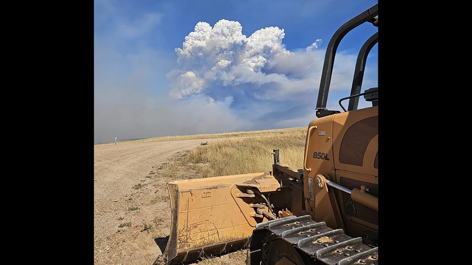 Bulldozers and heavy equipment work to build firelines around the Remington Fire.