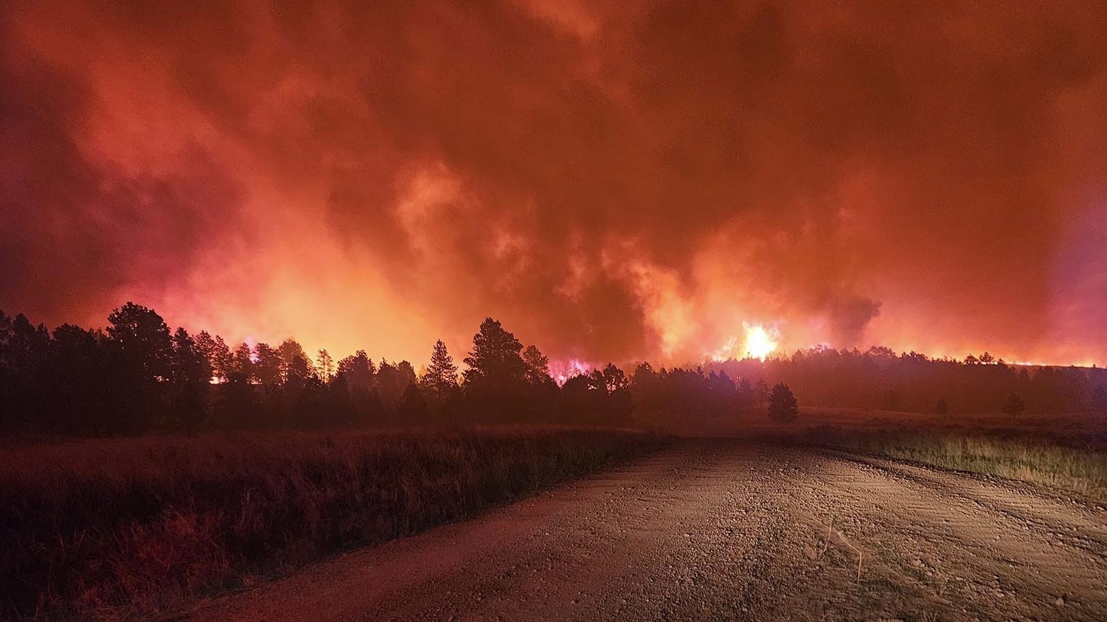 The Remington Fire casts a red glow at night.