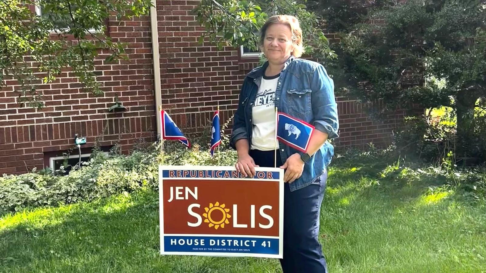 Cheyenne Democrat Jen Solis stands with one of her “Republicans For Jen Solis” yard signs.