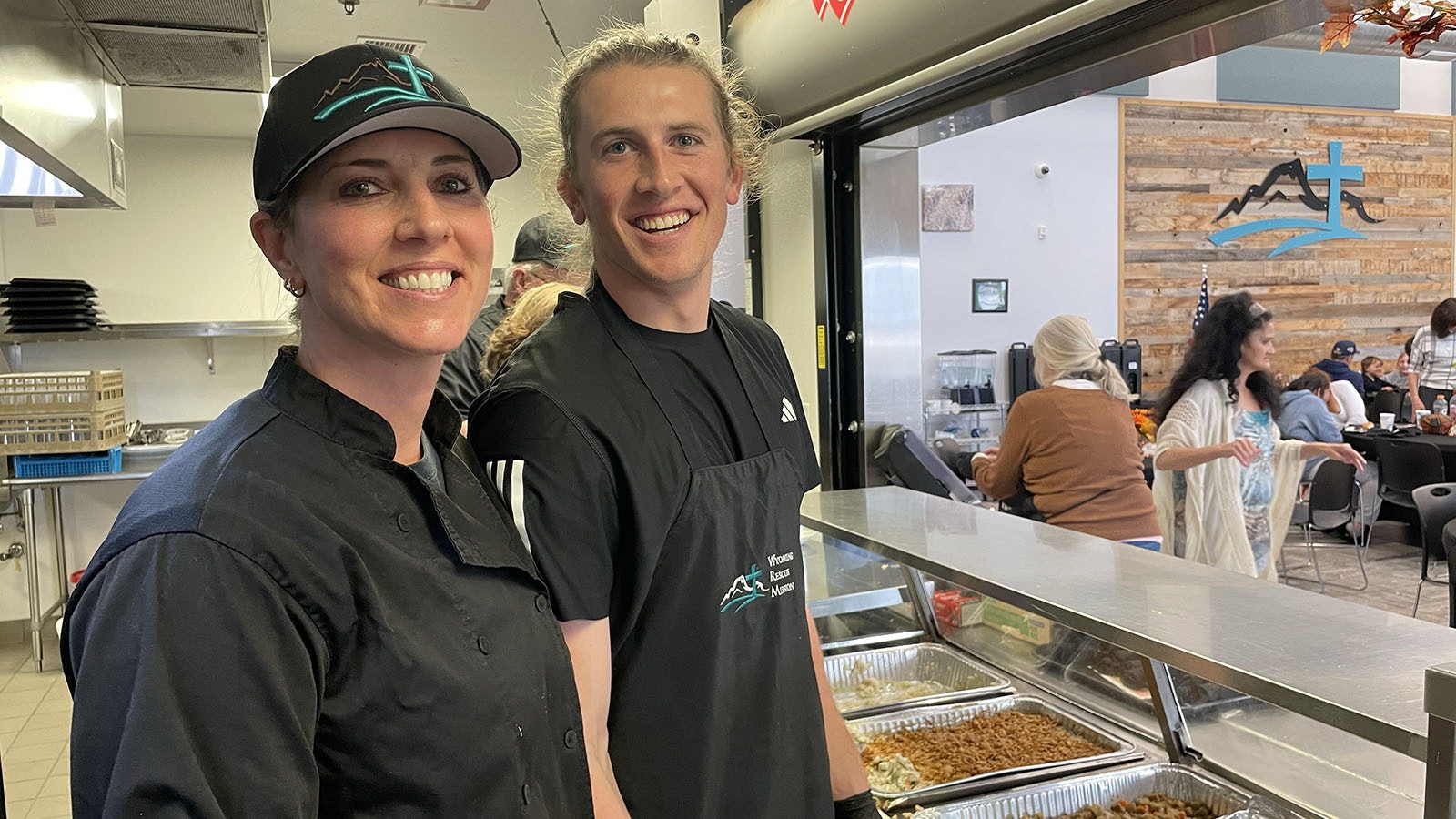 Amy Allaire smiles with son during volunteer work in the kitchen at the Wyoming Rescue Mission.