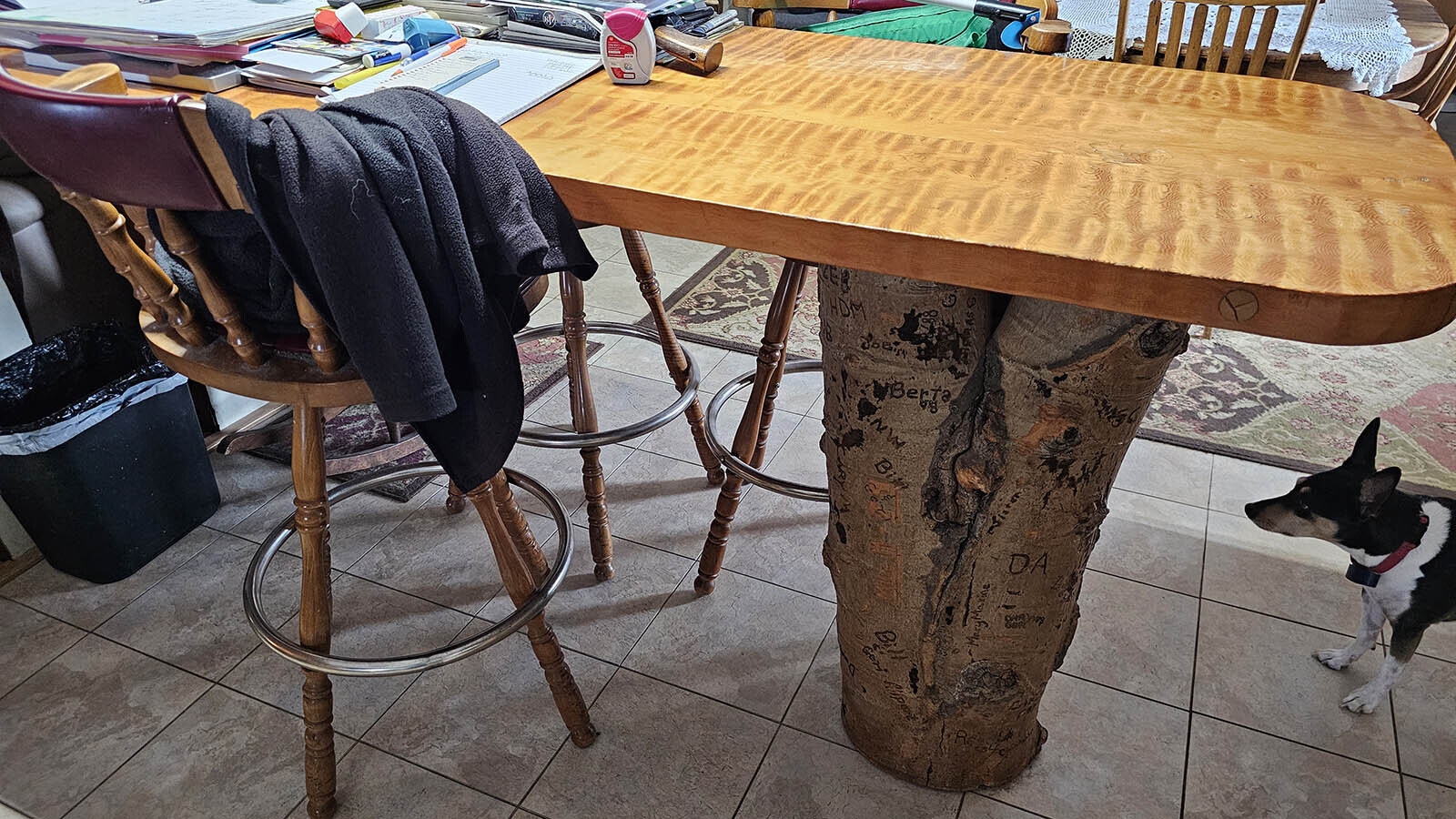 This table in Pat Burroughs’ home was made by her father from a pine tree in the surrounding area, while the stump holding it up is aspen. Over the years, guests have been invited to carve their initials in the stump.