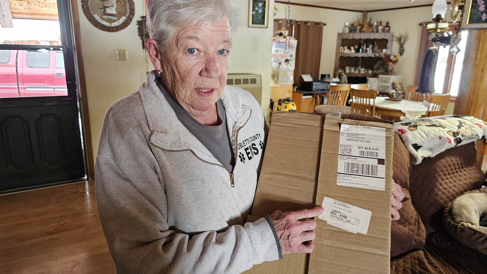 Pat Burroughs with one of the packages she recently received that has "Little Jackson Hole" written on it.