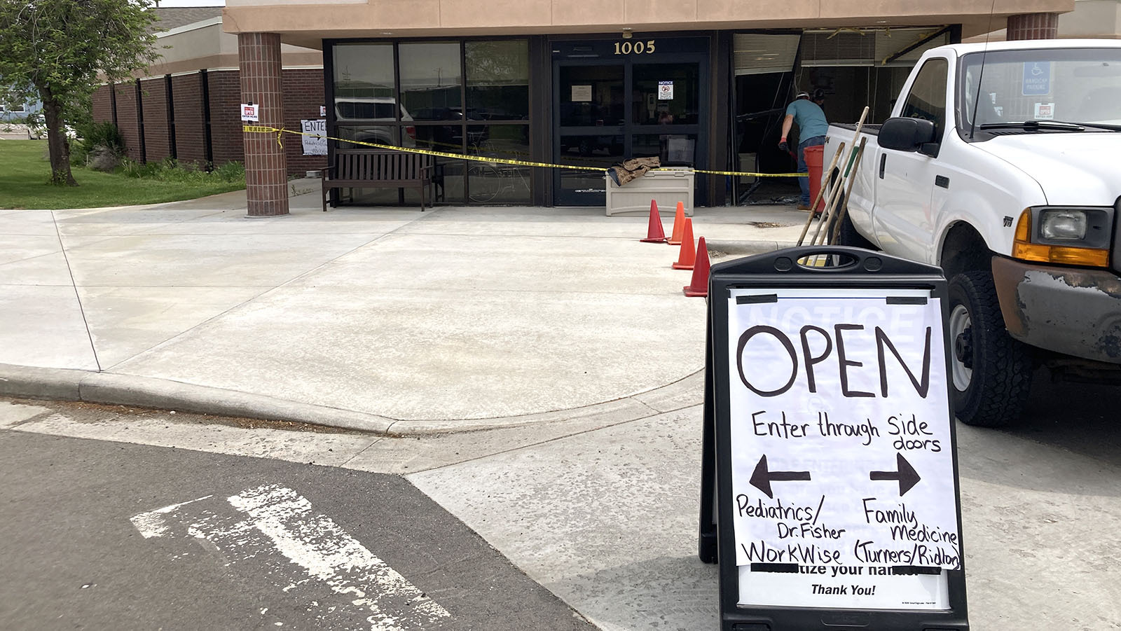Workers clean up the aftermath of a vehicle driving through the front lobby of Wind River Clinic in Riverton on Thursday morning.