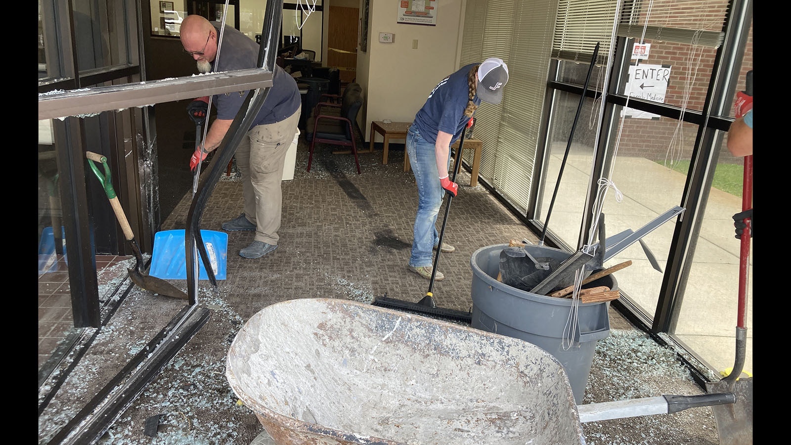 Workers clean up the aftermath of a vehicle driving through the front lobby of Wind River Clinic in Riverton on Thursday morning.
