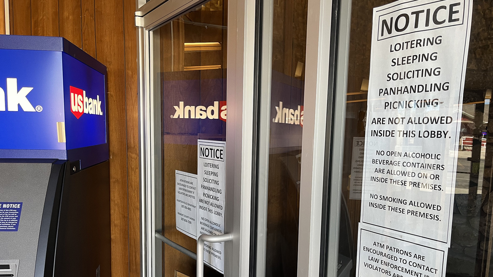 In the entryway to US Bank in Riverton are signs warning against public nuisances of many kinds.