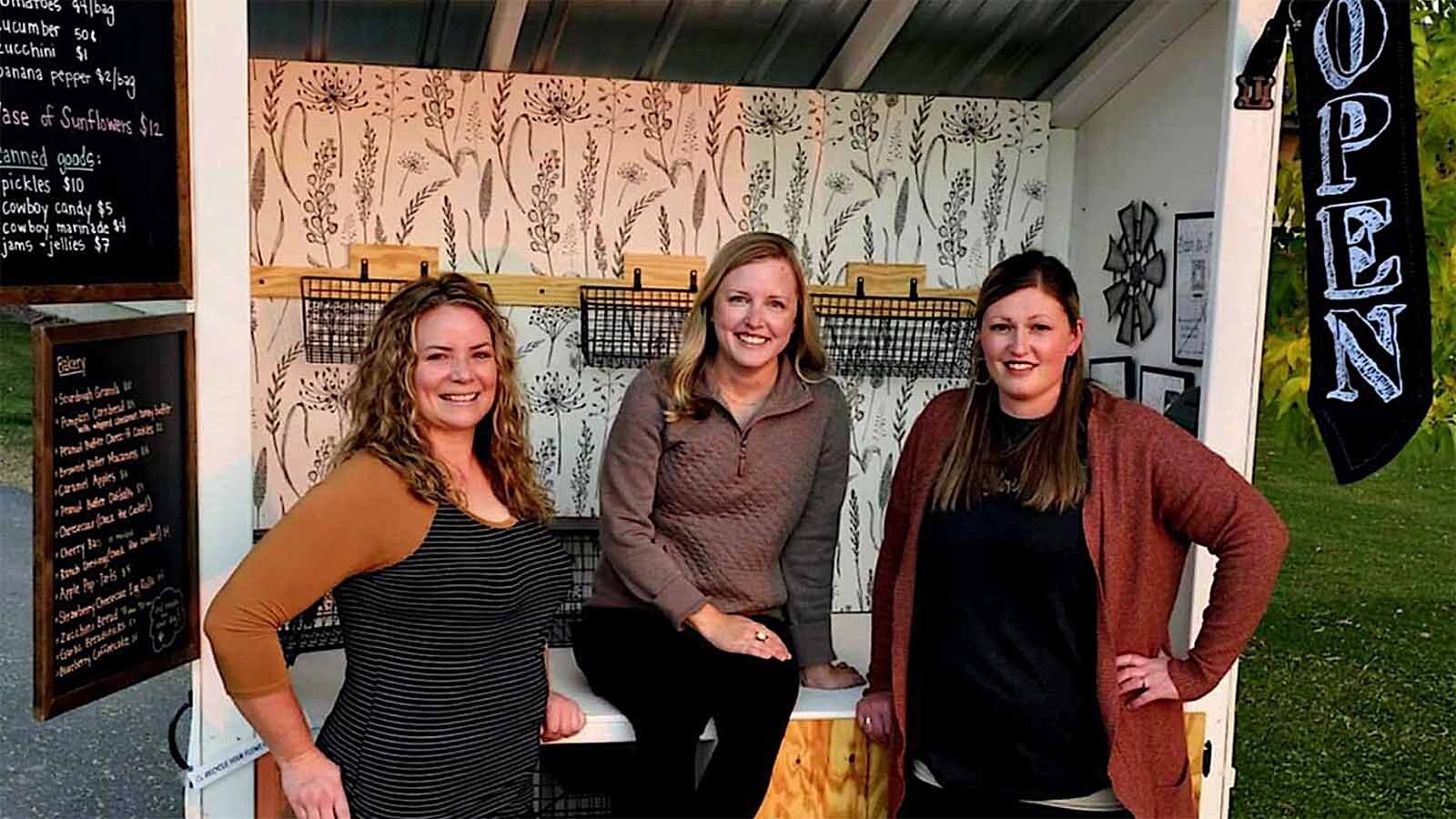 Kristen Scheuerman, fron left, Alex Hardy and Tabby Scheuerman are thankful for the fast success and honesty of customers at their roadside stand.