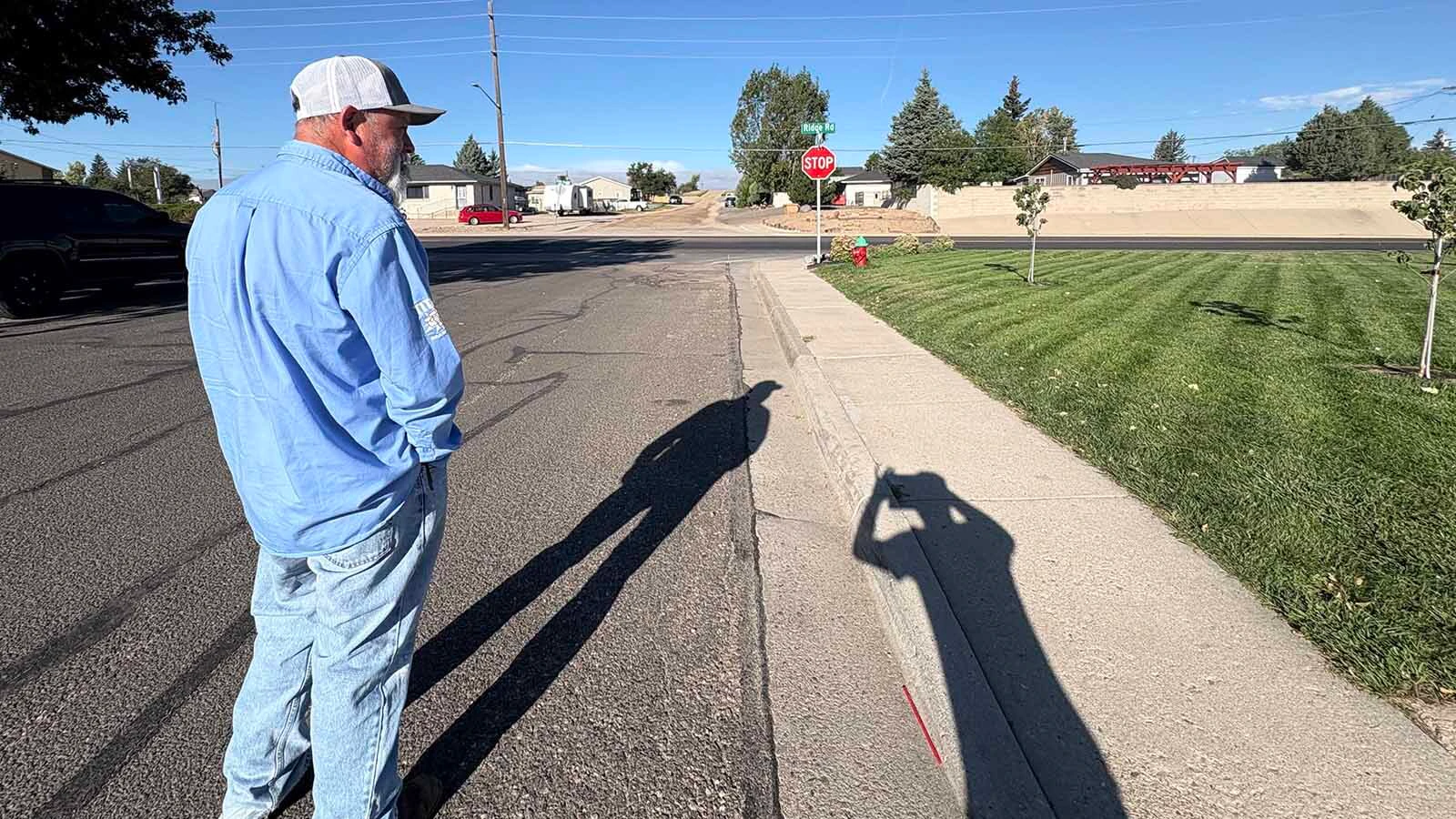 Neighbor Hector Juarez admires Shawn Ramsdell's lawn that had been freshly cut by a robot mower.
