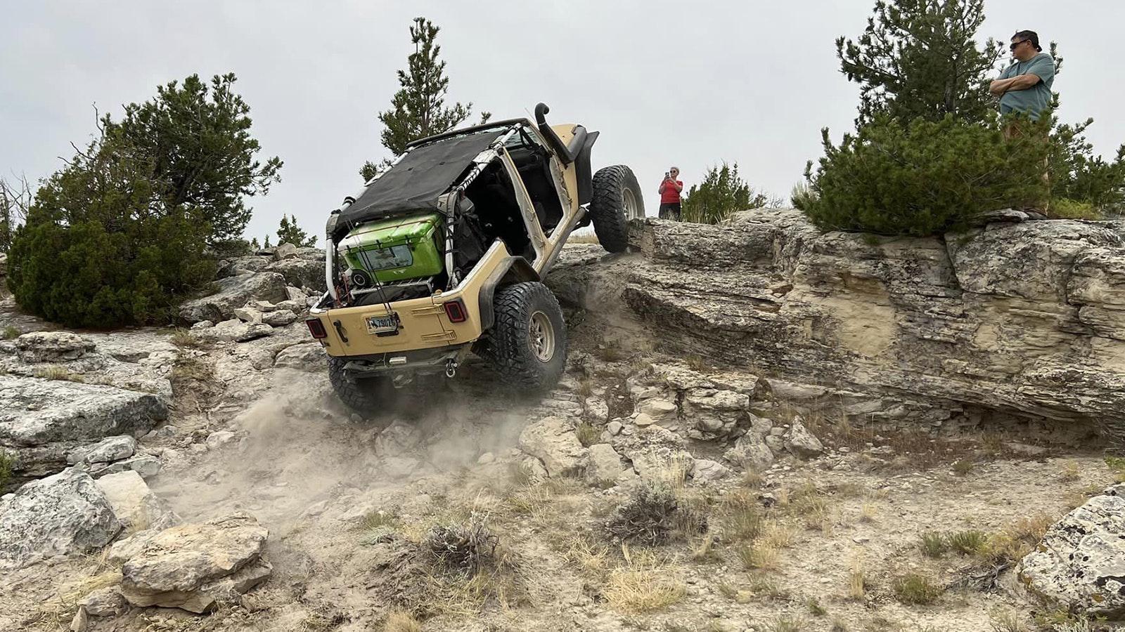 A rock crawlers navigates over a steep ledge.