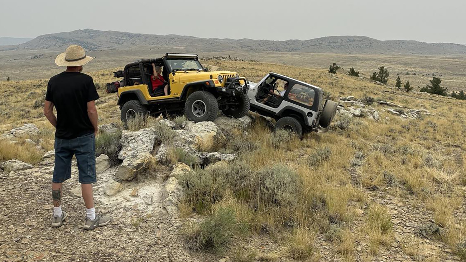 Two jeeps taking a moment to "play" on jutting rocks at Wagonhound Off-Road Park.