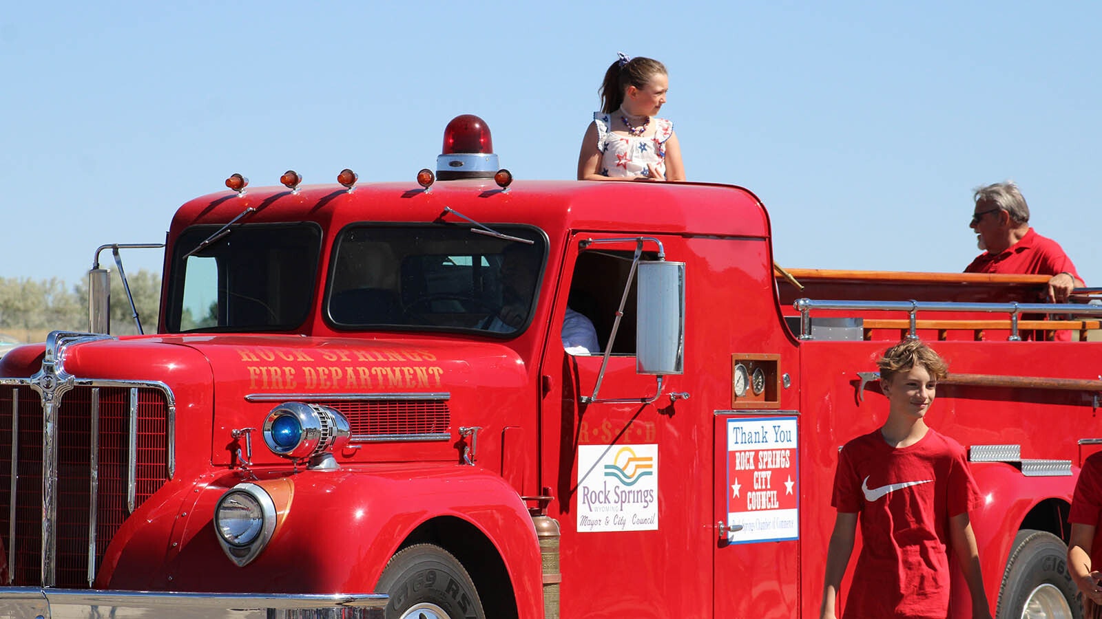 A lucky girl gets a ride in this vintage fire truck during Thursday's Rock Springs Liberty Parade.