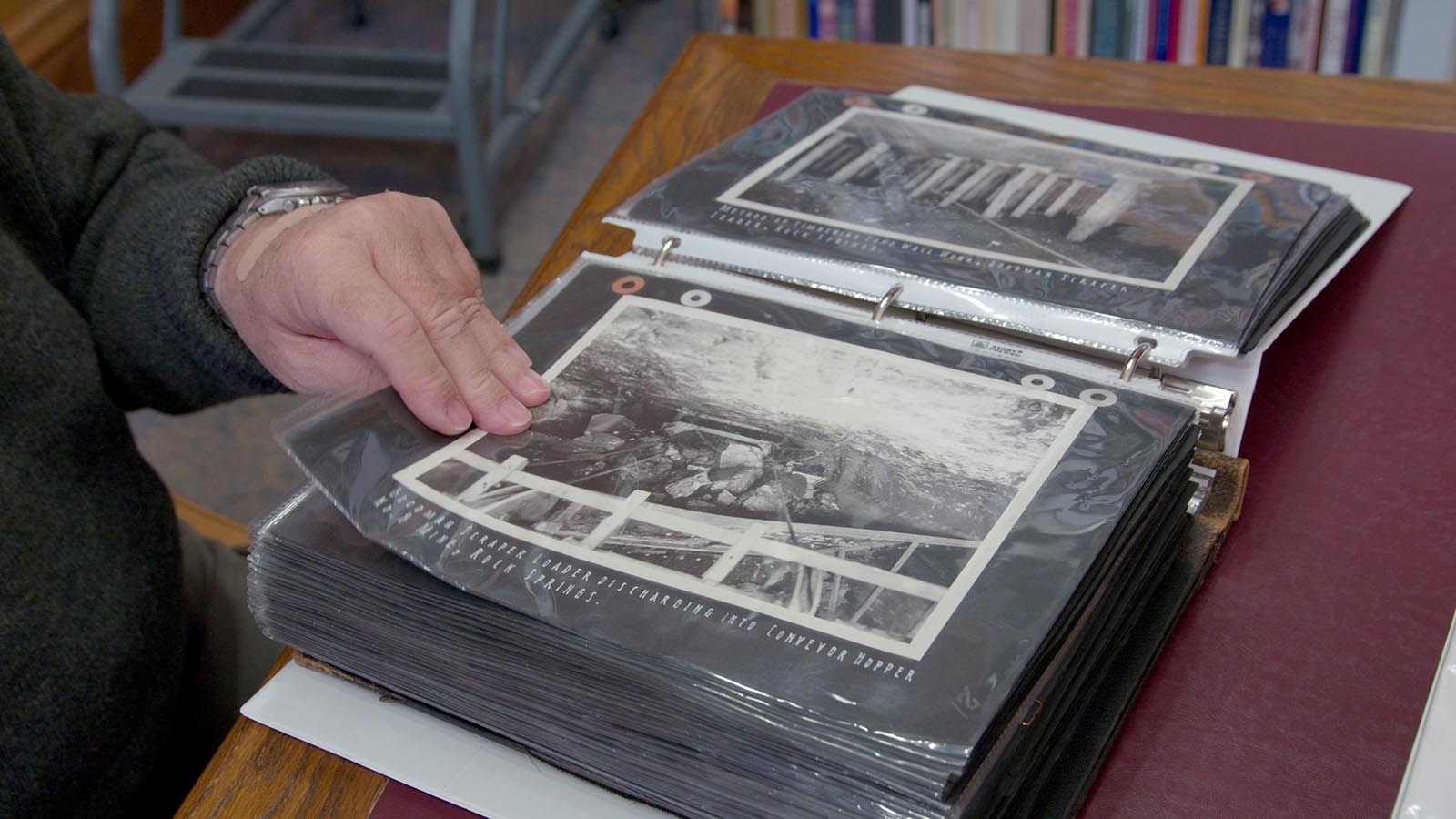 David Johnson looks at historical photographs from the first half of the 20th century while inside the Rock Springs Historical Museum.