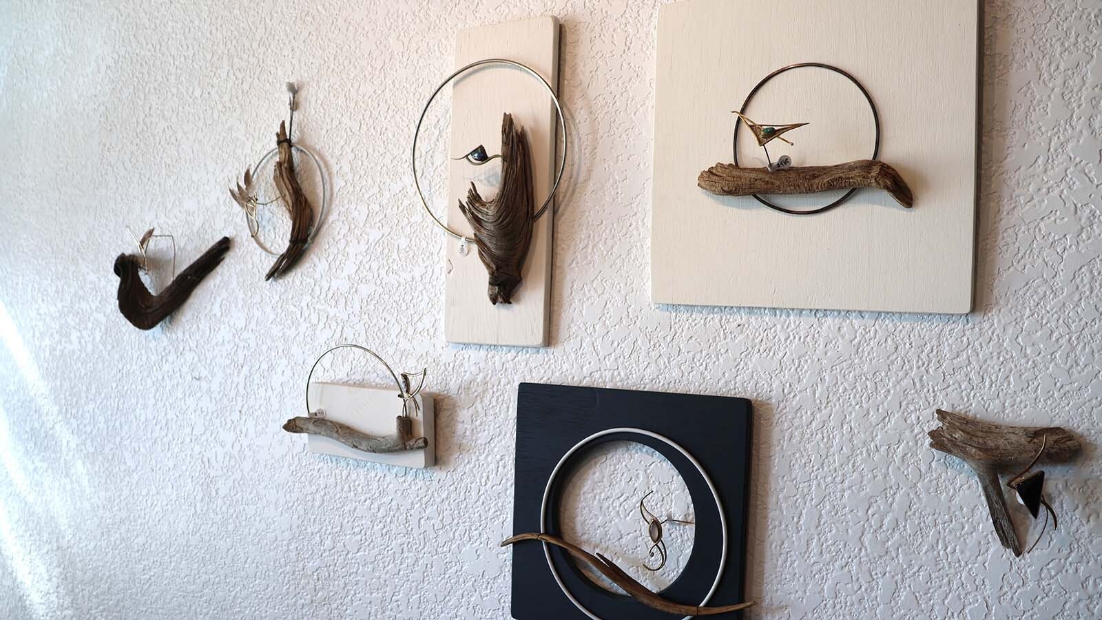 Part of an exhibit involving brooches and wall art remains at T. Hawk Studio. The brooches can be taken off the display and worn and then hung back up as part of the wall art.
