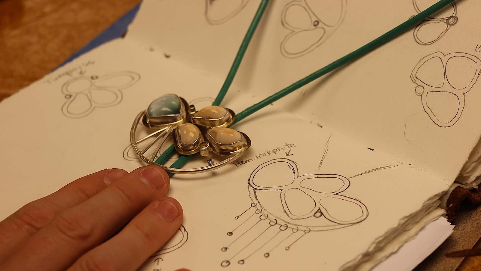 A sketch book shows Rachel Hawkinson’s thoughts before she actually made the piece.