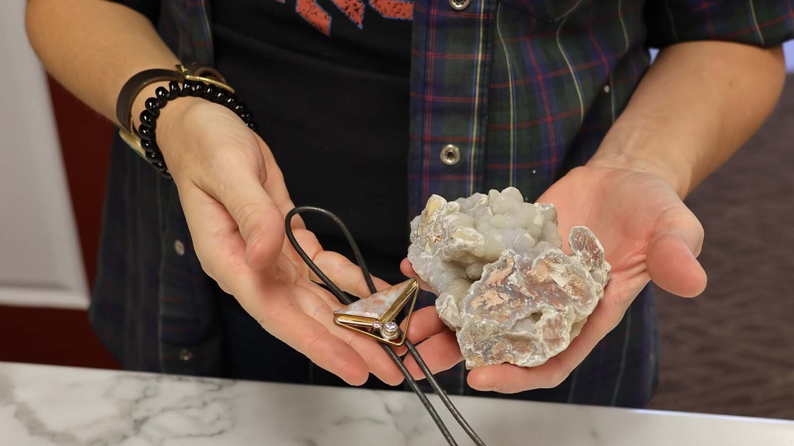 Rachel Hawkinson displays a piece of raw material and the finished product.