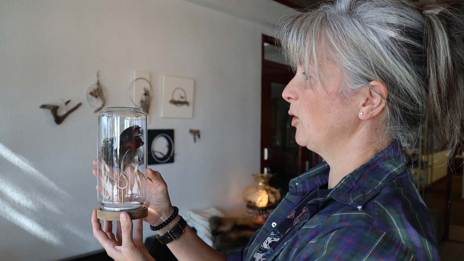 Rachel Hawkinson holds up one of the “Artists Are Scientists” ring specimens she has created that will be part of an upcoming exhibit.