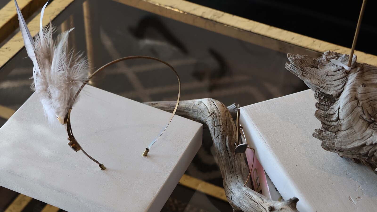 Tabletop jewelry sits as a table display, before being taken off and worn.
