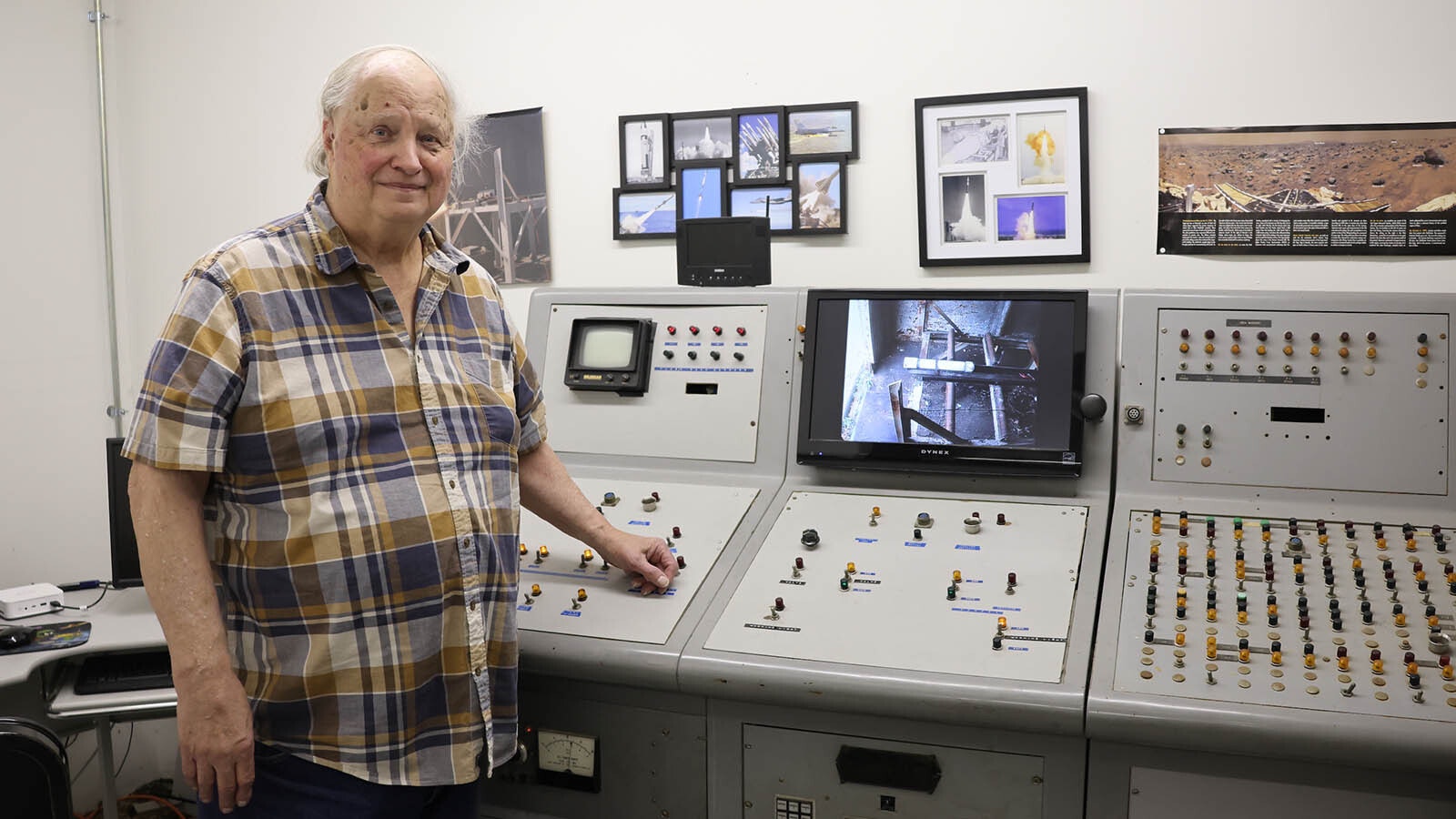 John Wickman, president of Wickman Spacecraft & Propulsion Co., stands next to the original launch control panel from Aerojet Propulsion Co. he bought for $200 back in the 1980s. The panel launched ICBMs and other military rockets during his time with the company.