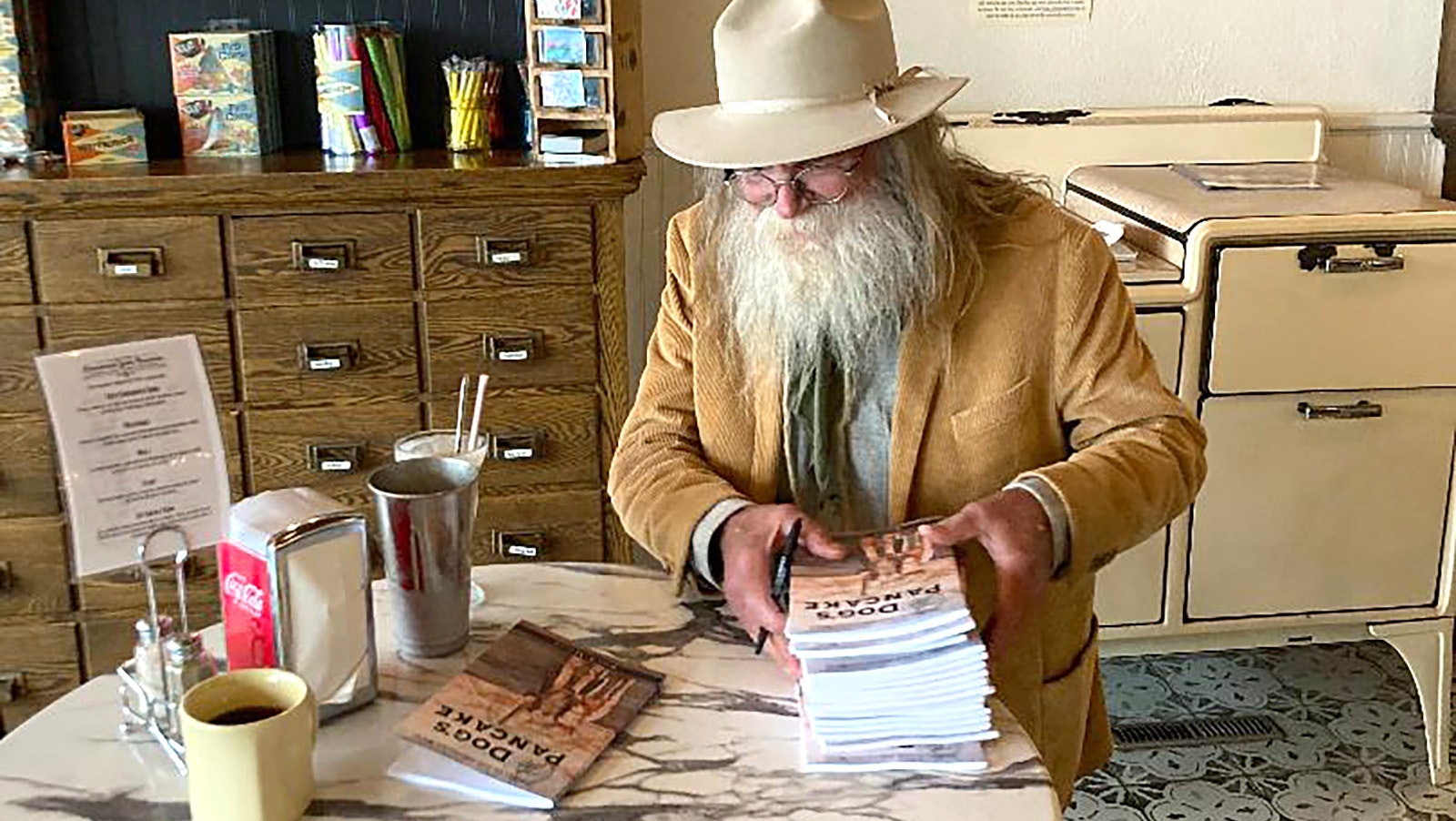 Rod Miller signs copies of his new volume of poetry, titled "The Dog's Pancake."