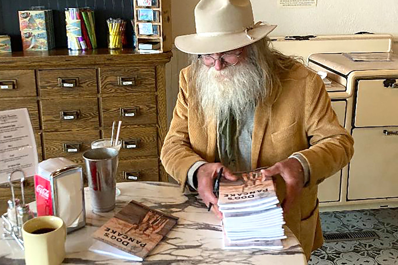 Rod Miller signs copies of his new volume of poetry, titled "The Dog's Pancake."