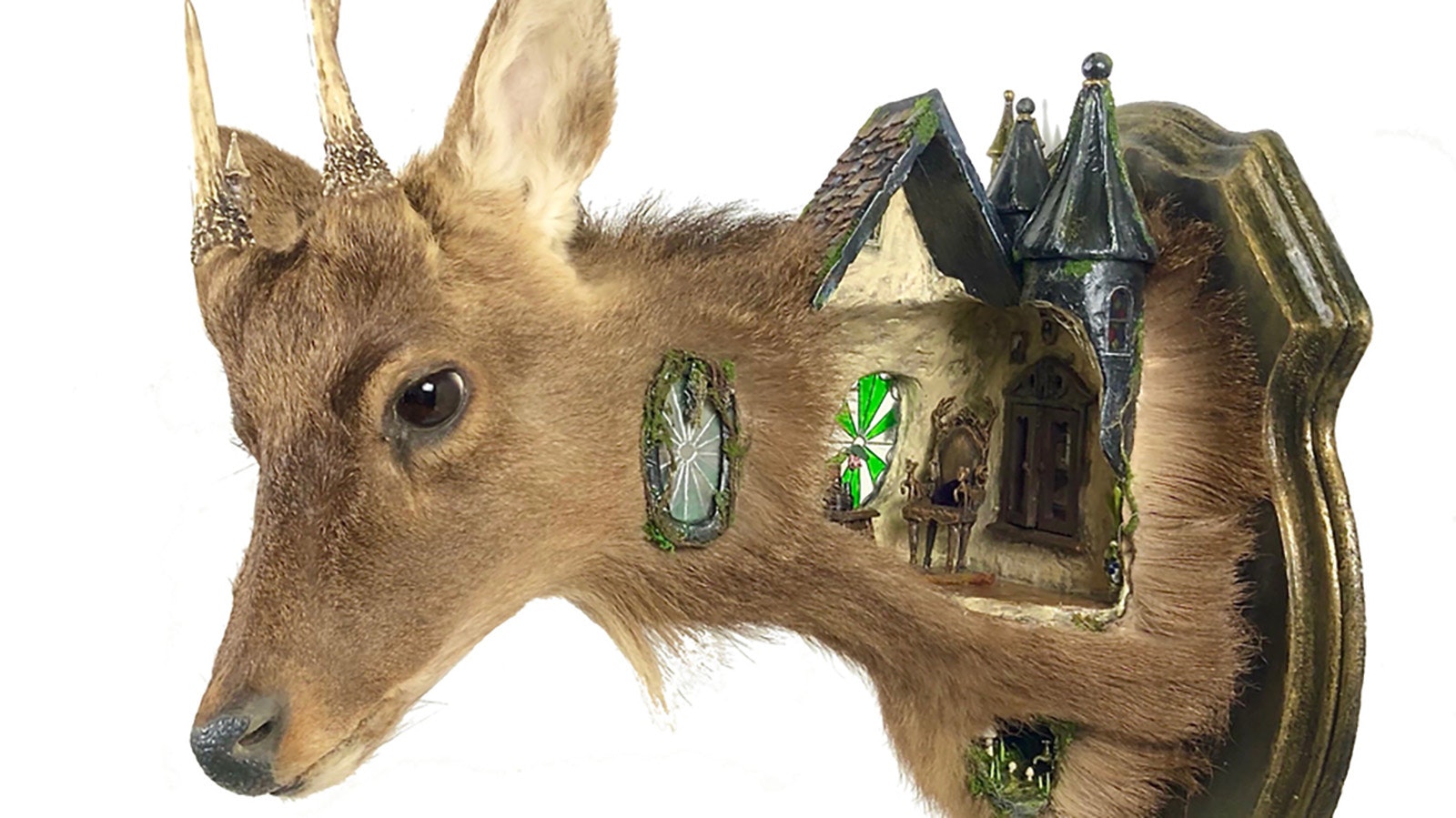A rogue taxidermy art piece by Brooke Weston called Deer Witch Cottage.