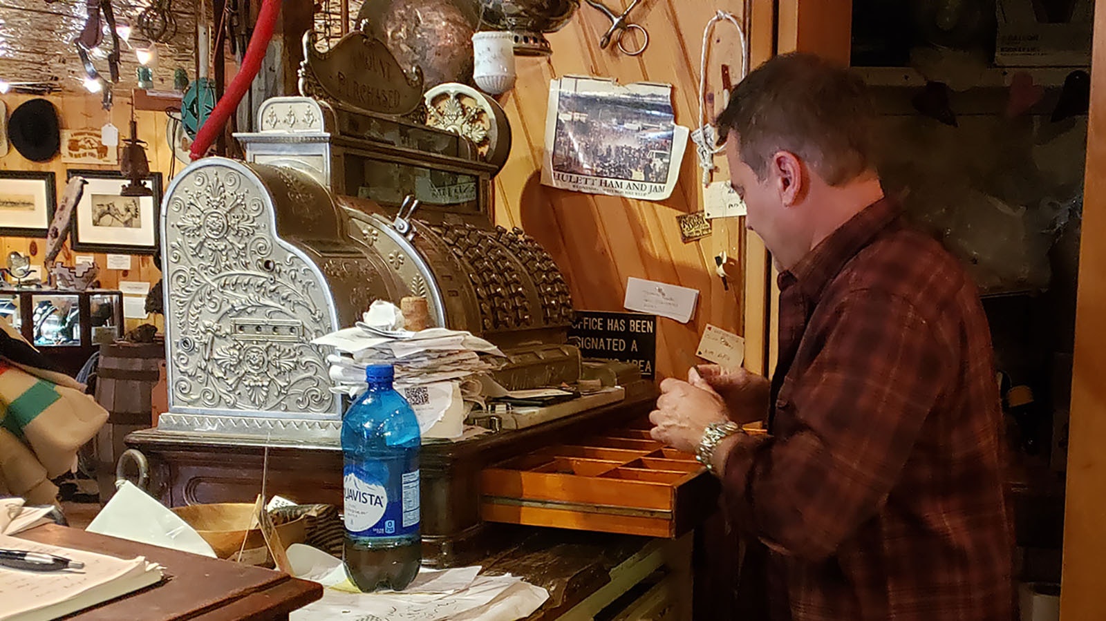 Bob Coronato uses an old fashioned cash register at his store.