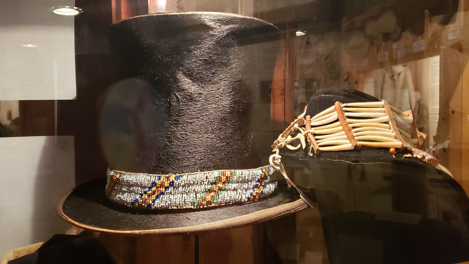 This hat would have been a gift from settlers to Native Americans. The beads would have been something added by the owner later.