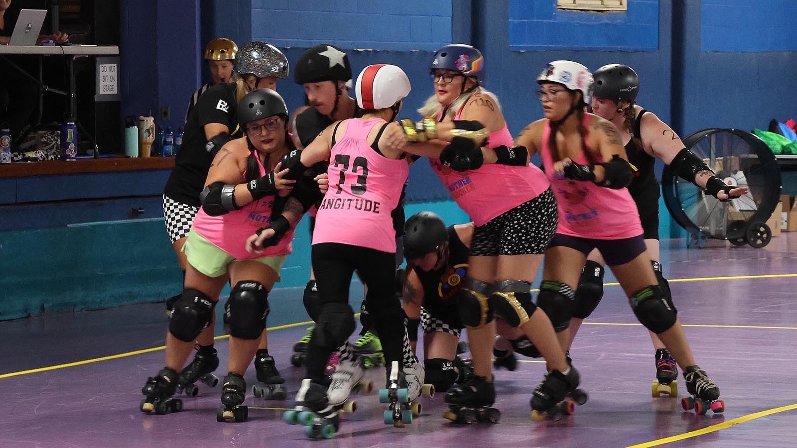 The male skater with the star on his helmet, the jammer, tries to break through his opponents during a “jam” at Summer Bash 5-on-5 Tournament in Mills.